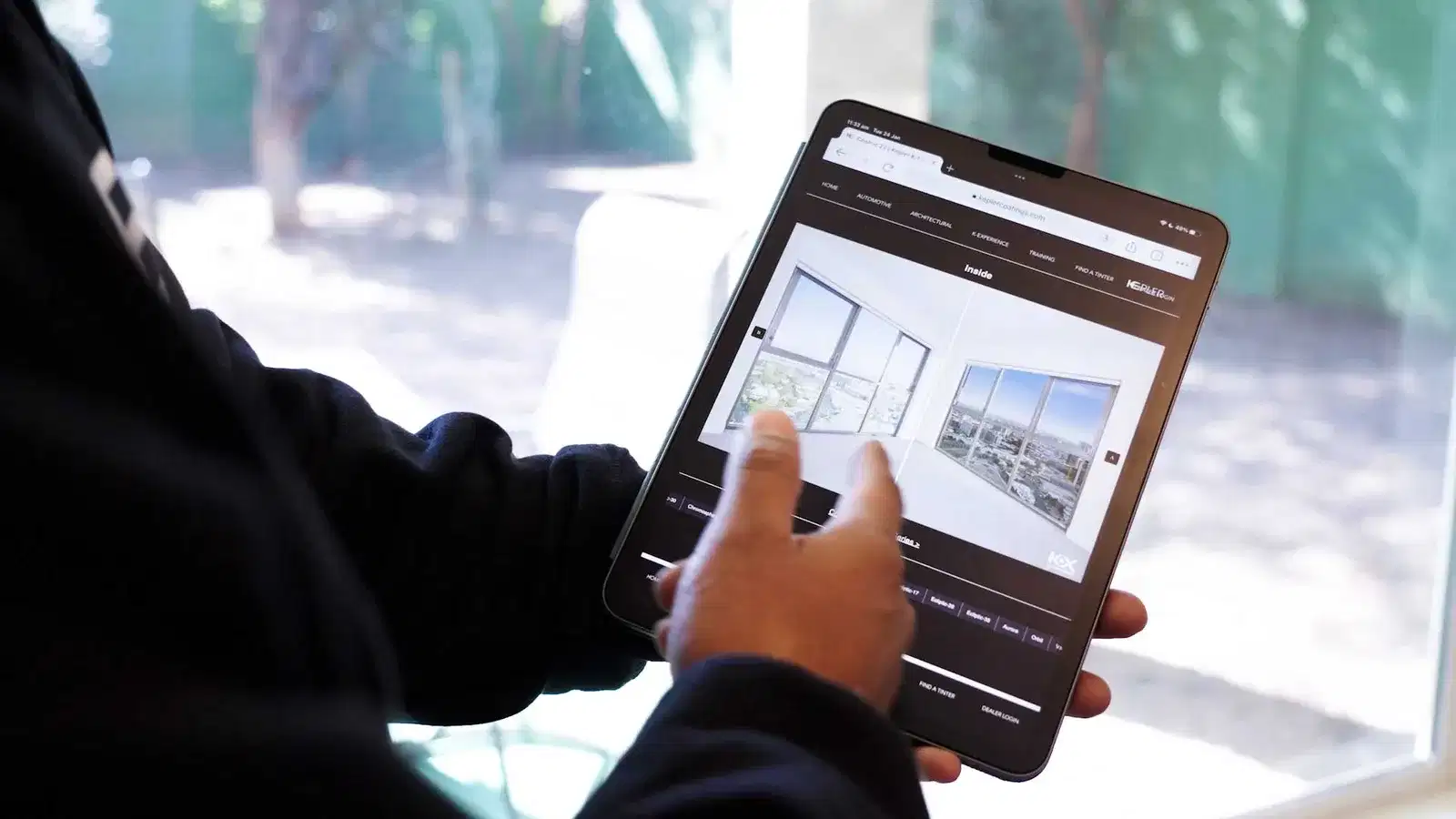Dealer showing Union architectural film options on a tablet
