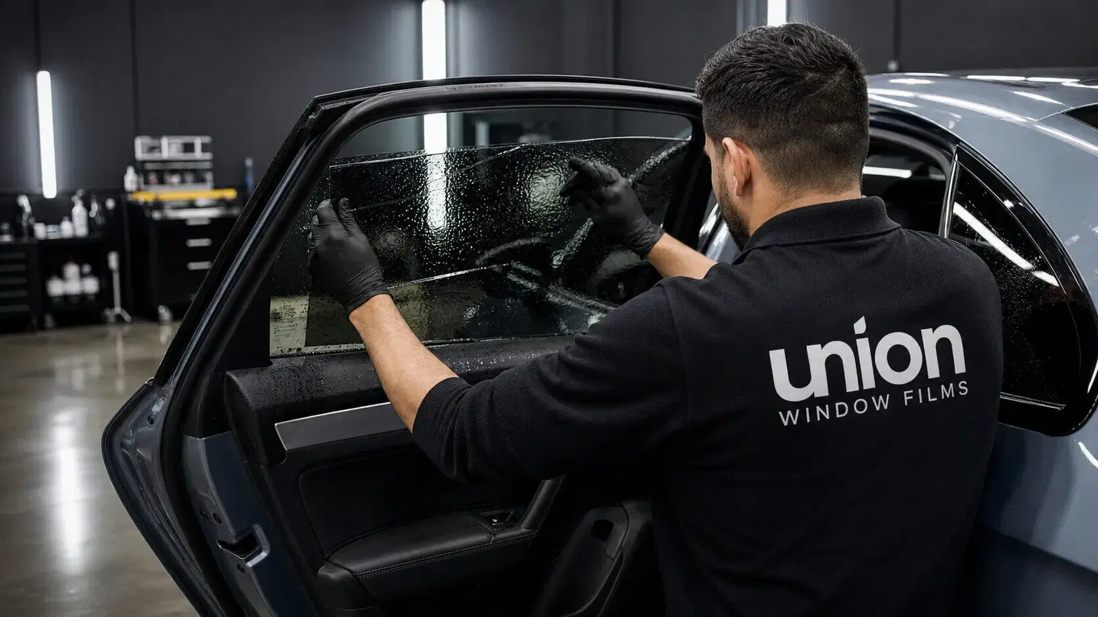 Union Window Films installer tinting a car door window